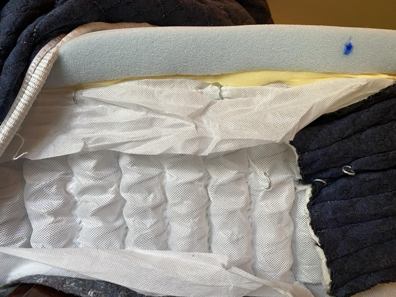 Innerspring mattress layers cut open showing coil system that allows air circulation